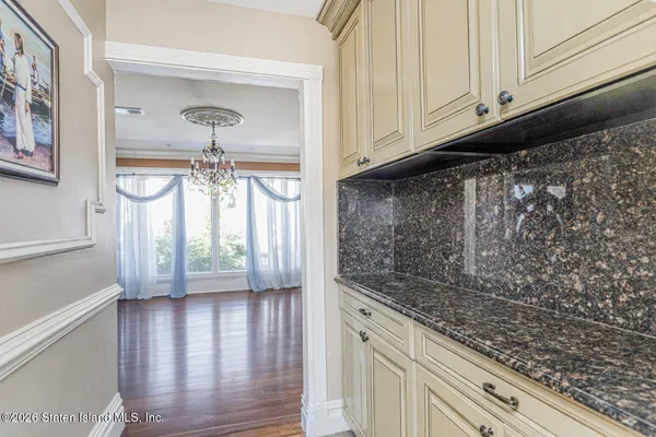 a kitchen with granite countertop a sink and cabinets