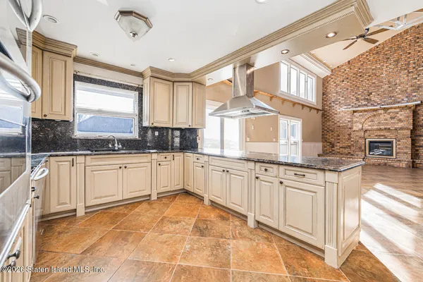 a kitchen with kitchen island a counter top space a sink and appliances