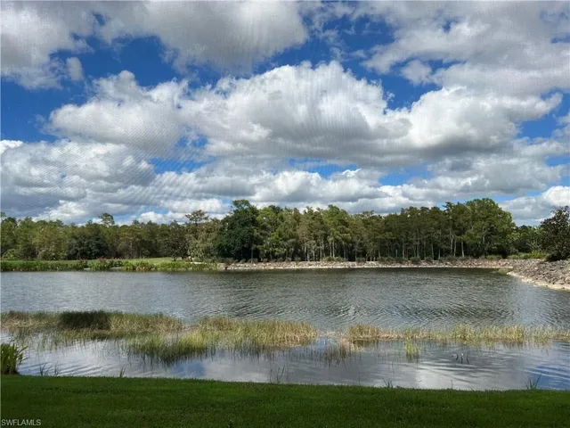 a view of a lake with houses in the back
