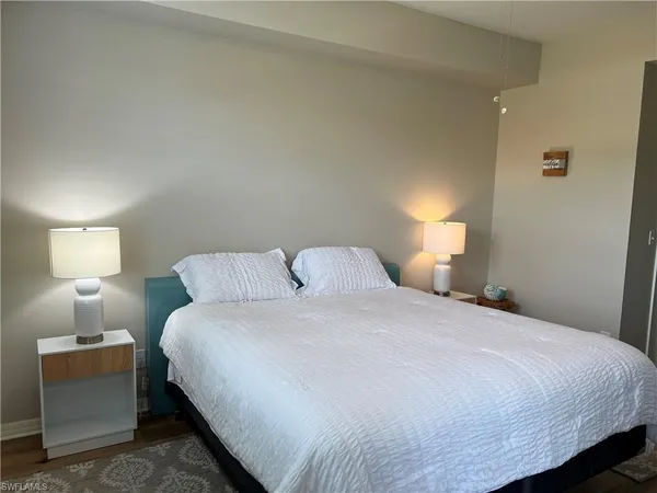a bedroom with a bed and a lamp