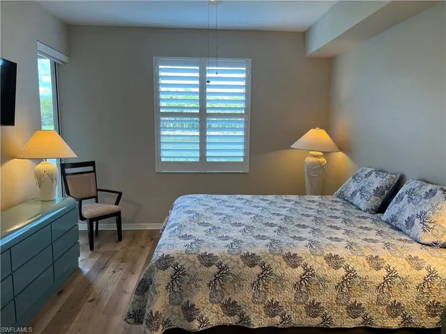 a bedroom with a bed and a chair