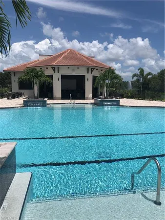 a view of swimming pool with outdoor seating and a garden