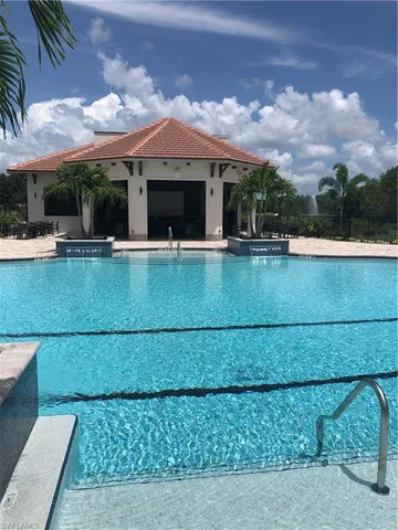 a view of swimming pool with outdoor seating and a garden