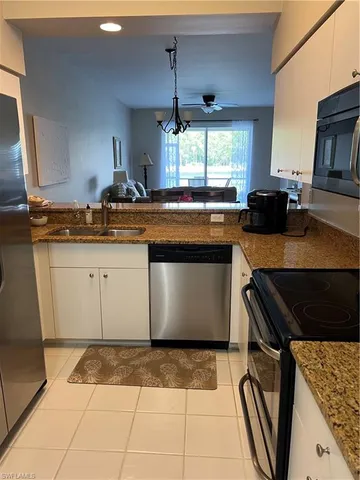 a kitchen with granite countertop a stove a sink and a granite counter tops