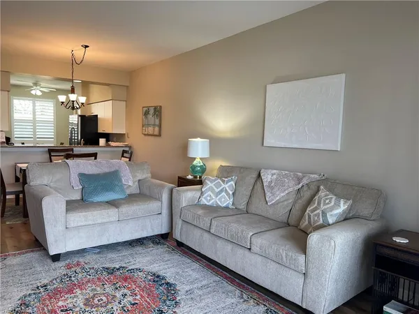 a living room with furniture and a chandelier