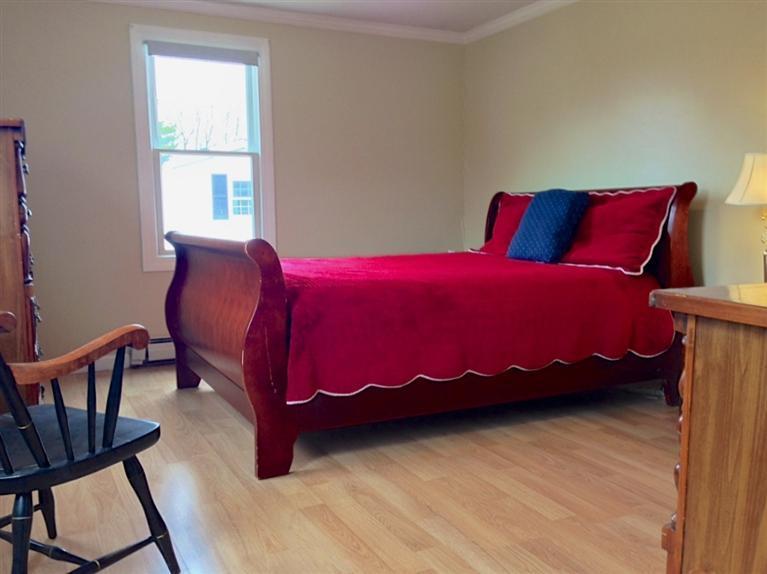 46 Oak Neck Road Hyannis, MA 02601 - Photo 19 of 21 a bedroom with a bed and wooden floor