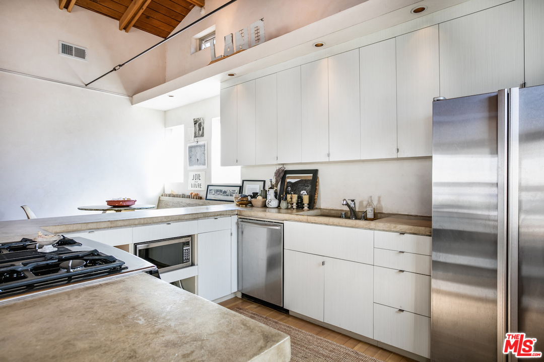650 Sunset Avenue Venice, CA 90291 - Photo 6 of 20 a kitchen with a sink stainless steel appliances and cabinets