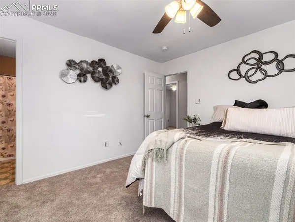 a bedroom with a large bed and a chandelier