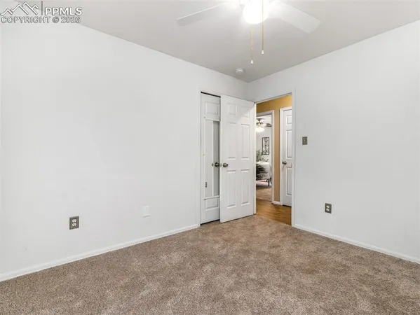 an empty room with an entryway and wooden floor