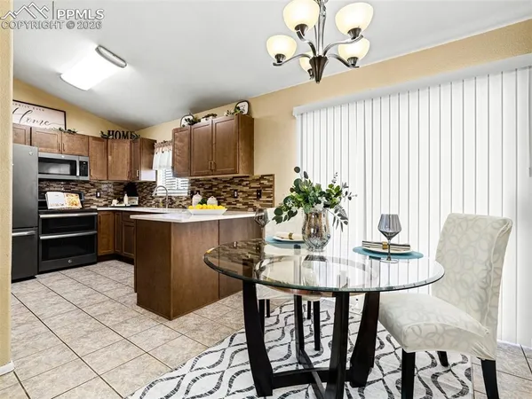 a dining room with furniture and window