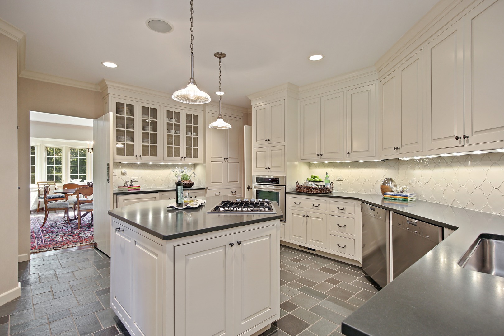 712 Taft Road Hinsdale, IL 60521 - Photo 3 of 25 a kitchen with granite countertop a sink stove and cabinets