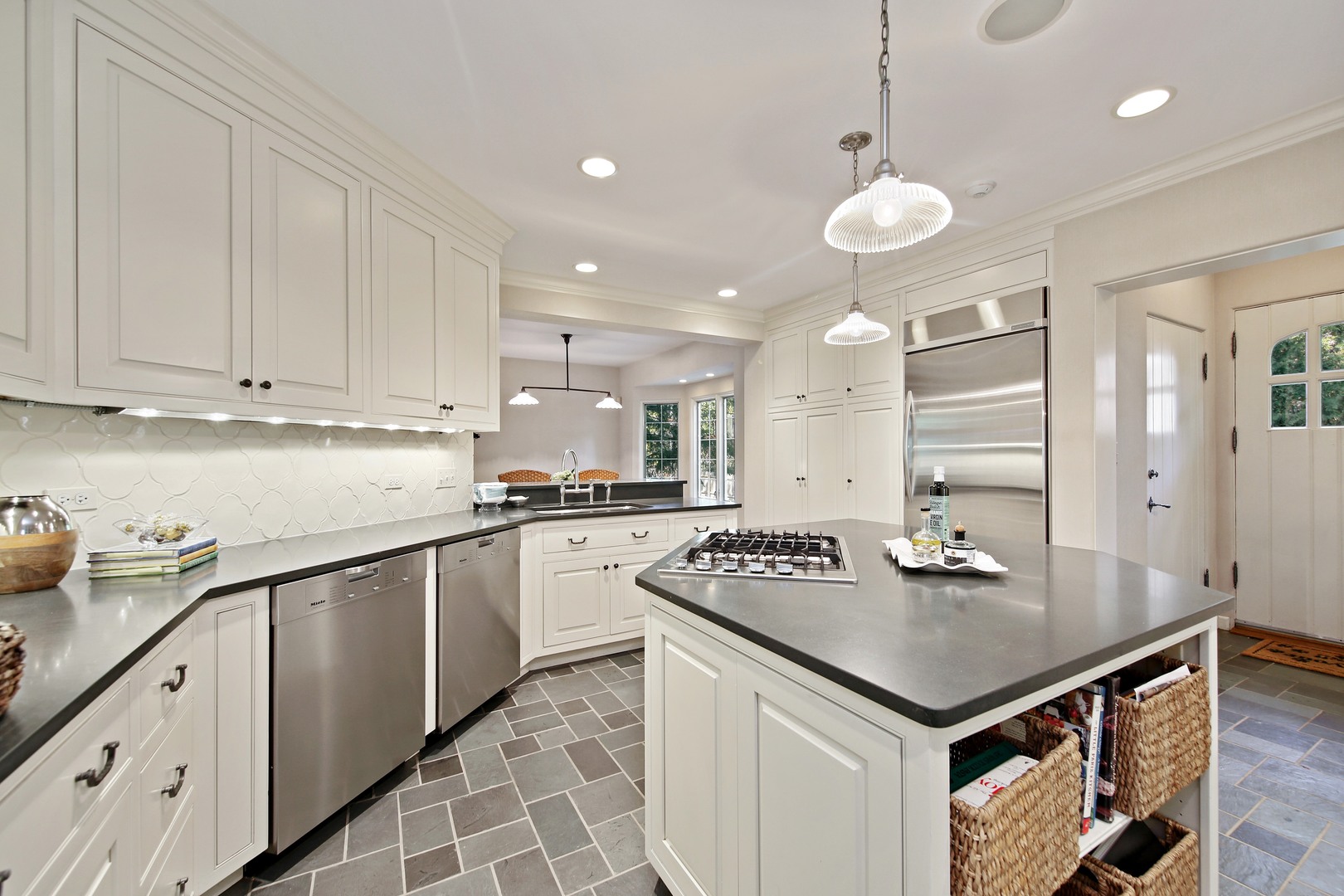 712 Taft Road Hinsdale, IL 60521 - Photo 4 of 25 a kitchen with kitchen island granite countertop a sink a center island and cabinets