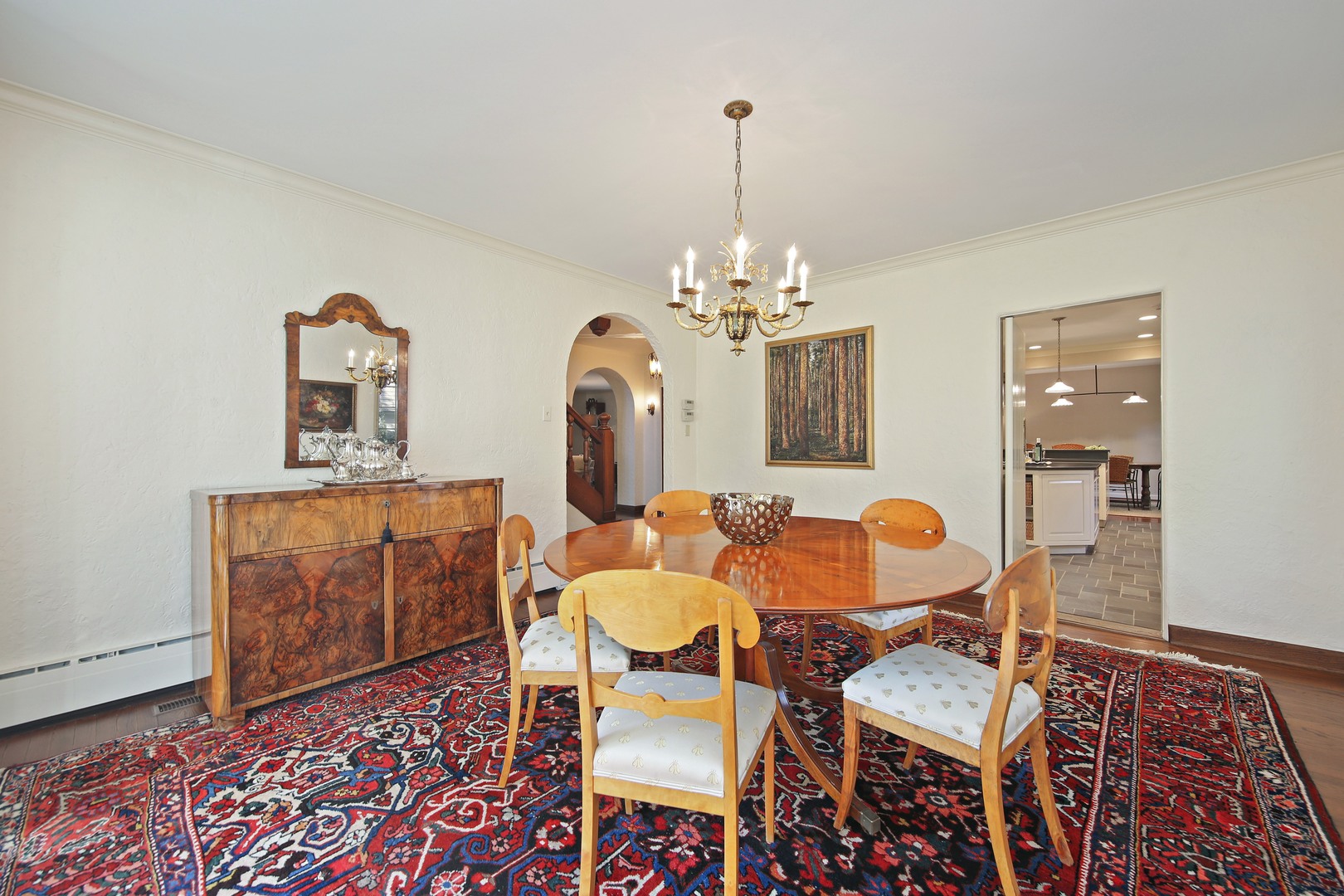 712 Taft Road Hinsdale, IL 60521 - Photo 9 of 25 a dining room with wooden floor a chandelier a wooden table and chairs
