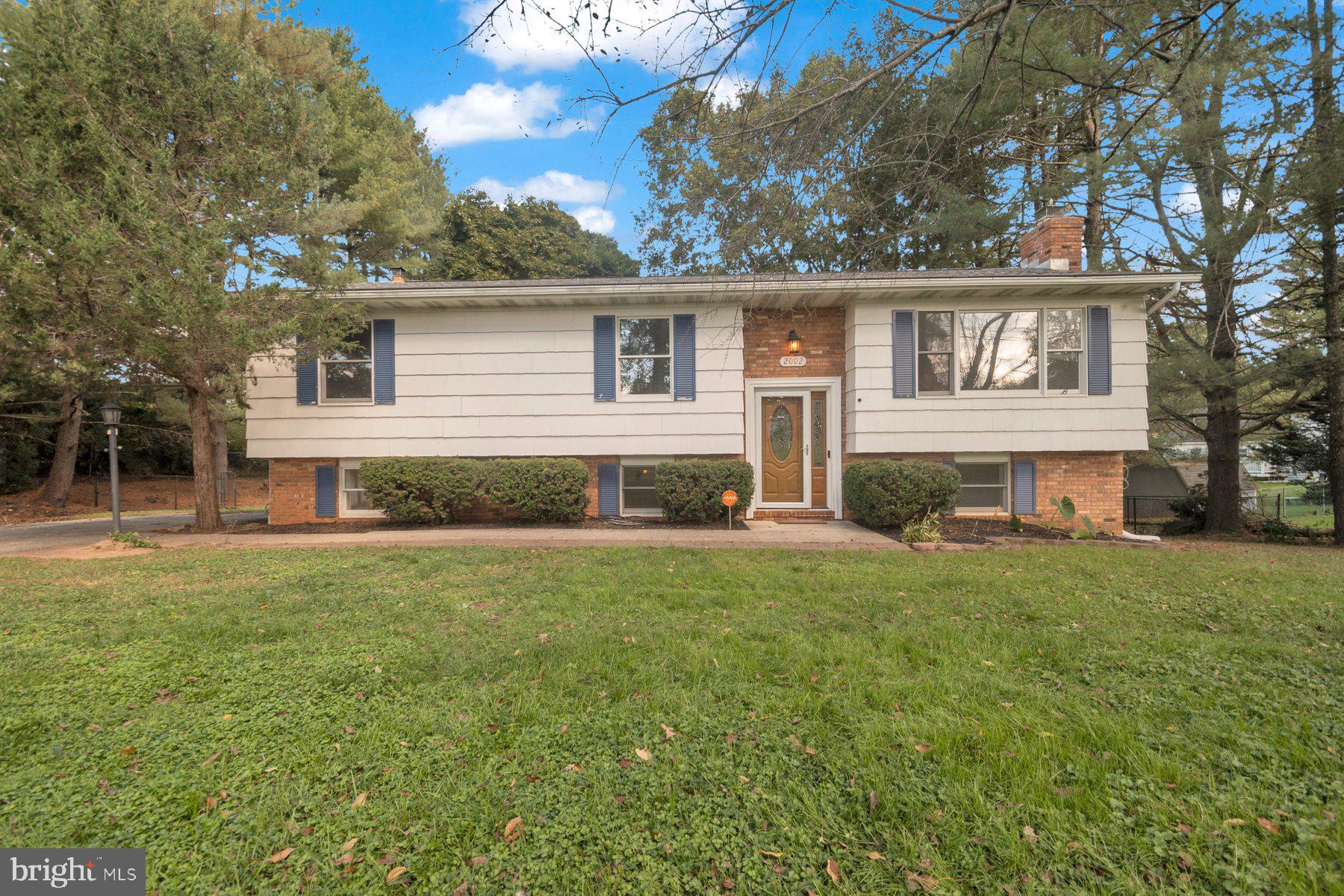 2002 Deer Park Road Finksburg, MD 21048 - Photo 1 of 36 a view of a yard in front of a house with large trees