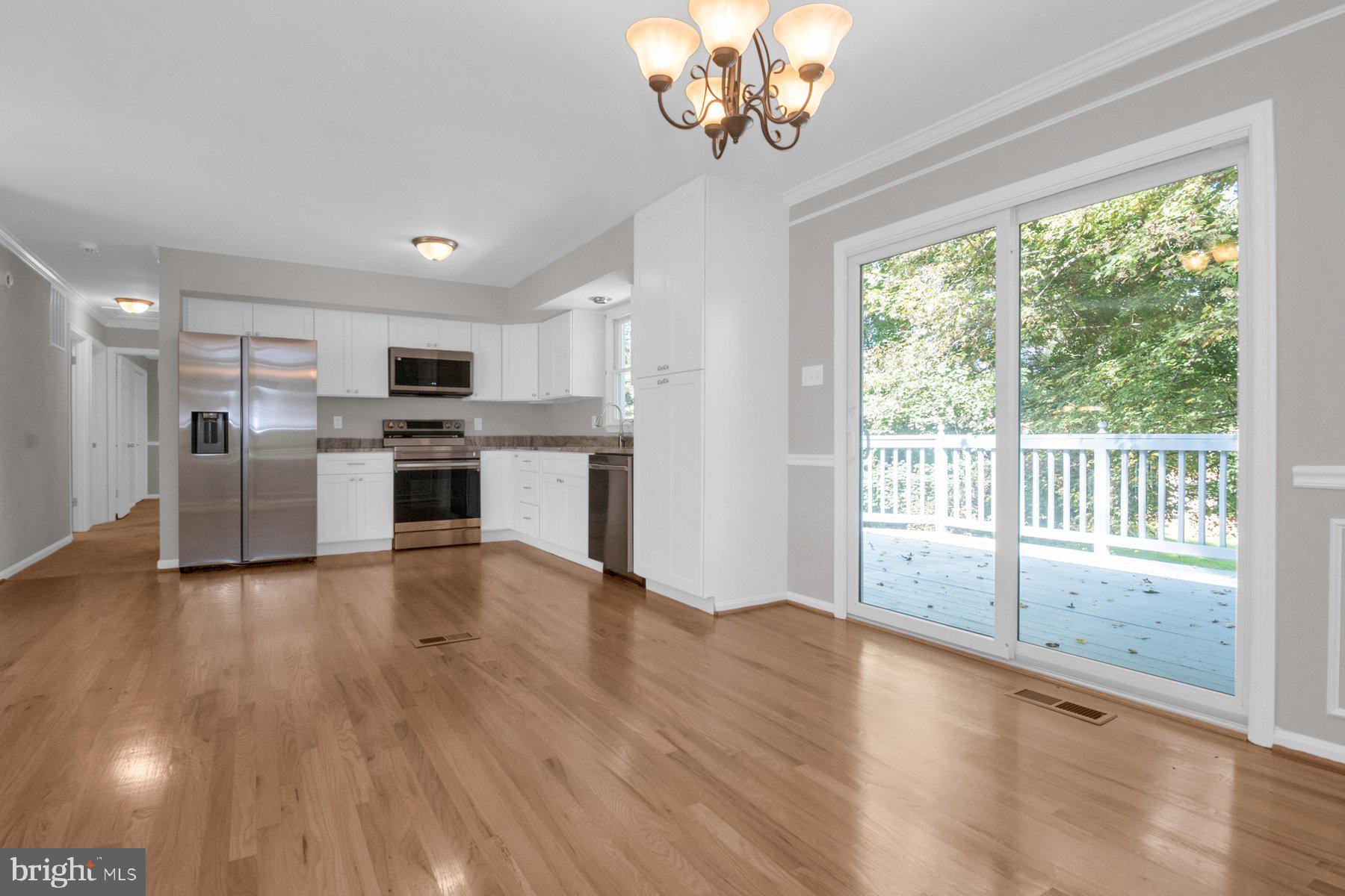 2002 Deer Park Road Finksburg, MD 21048 - Photo 6 of 36 a view of a kitchen with a stove wooden cabinets and a fireplace
