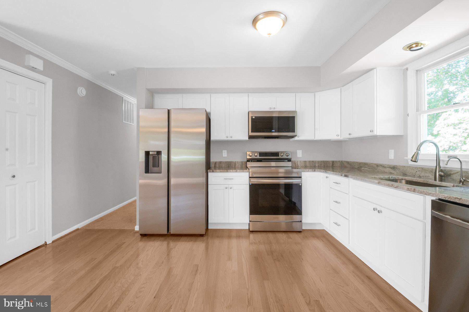 2002 Deer Park Road Finksburg, MD 21048 - Photo 7 of 36 a kitchen with stainless steel appliances granite countertop a stove a sink and a refrigerator