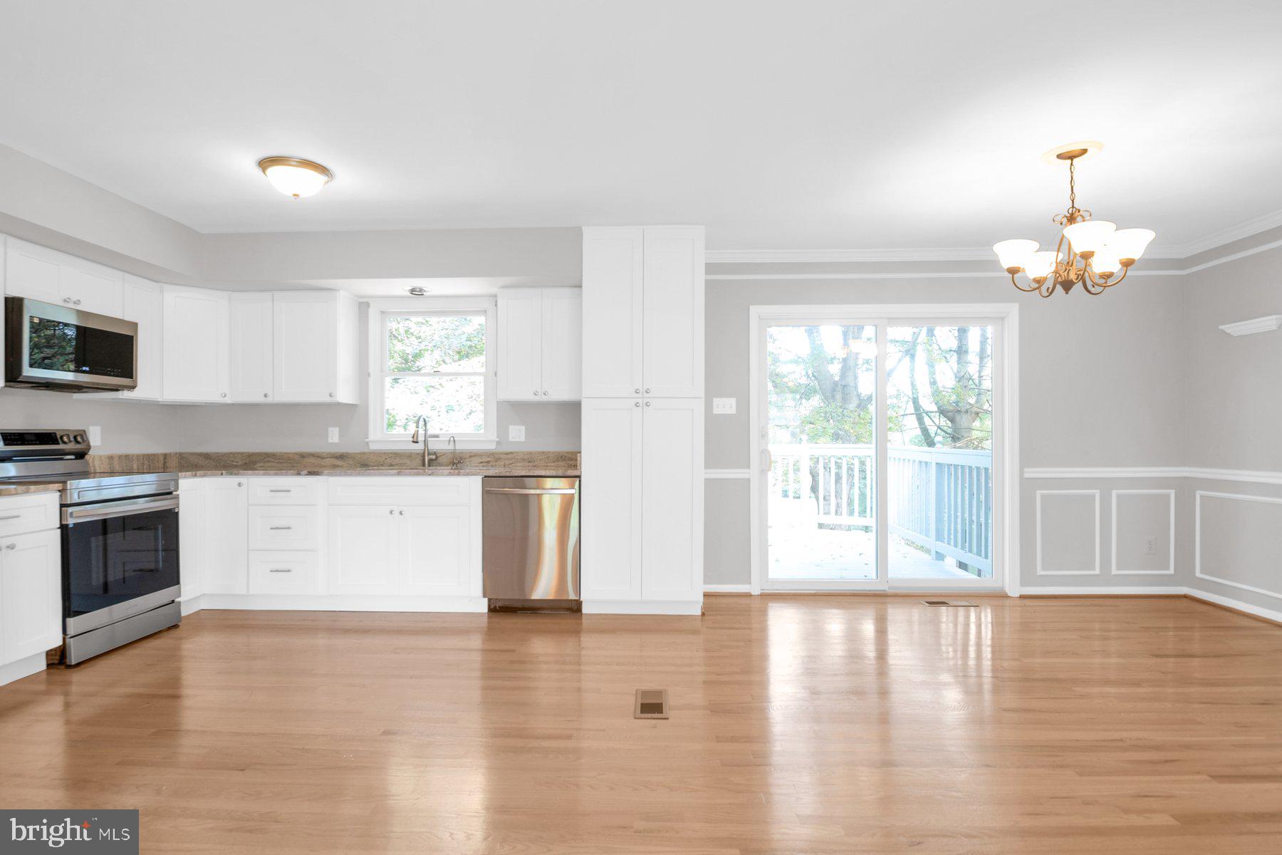 2002 Deer Park Road Finksburg, MD 21048 - Photo 10 of 36 a open kitchen with granite countertop a stove top oven a sink dishwasher and white cabinets with wooden floor