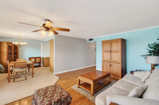 a living room with furniture rug and wooden floor