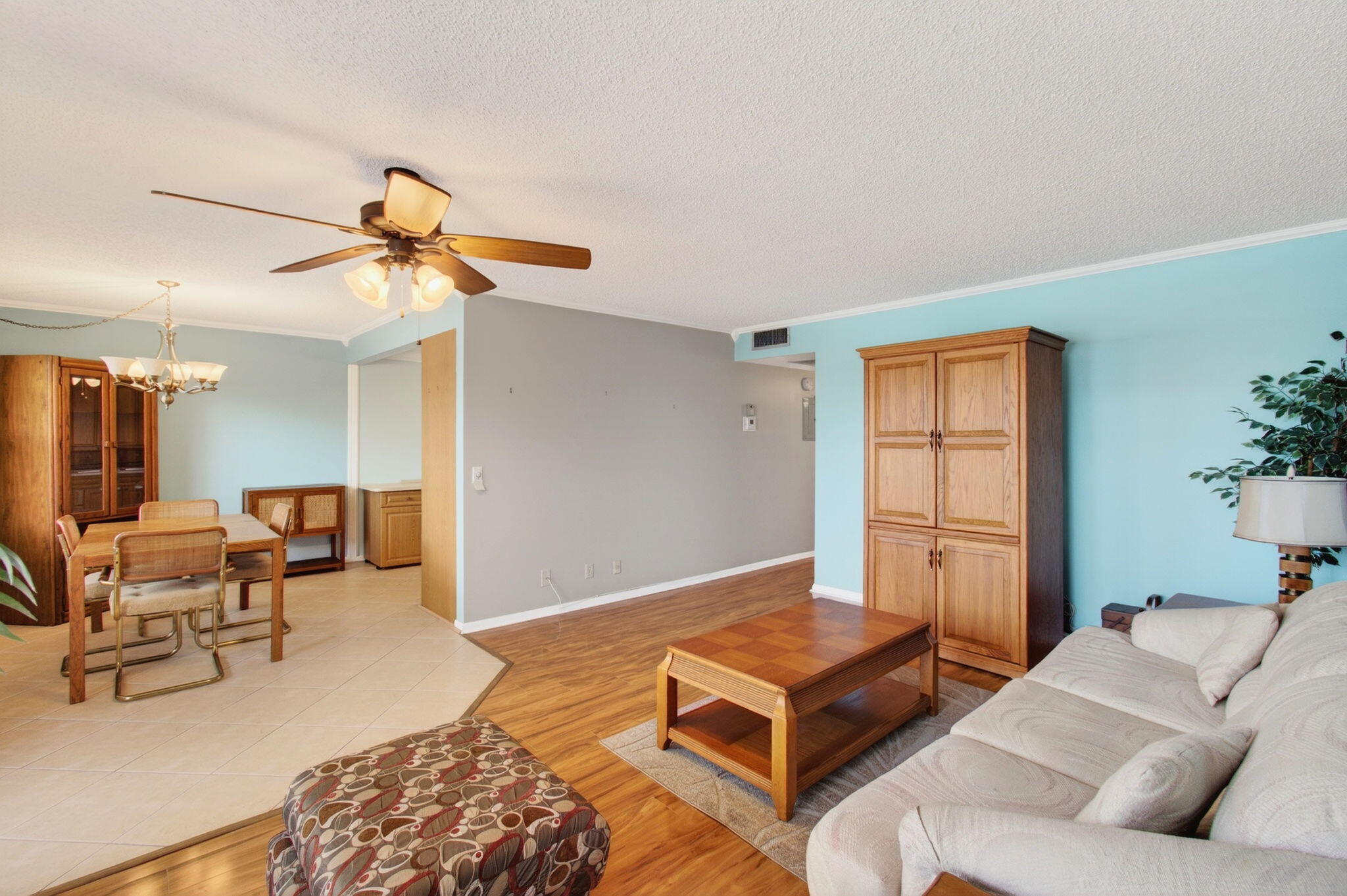 a living room with furniture rug and wooden floor