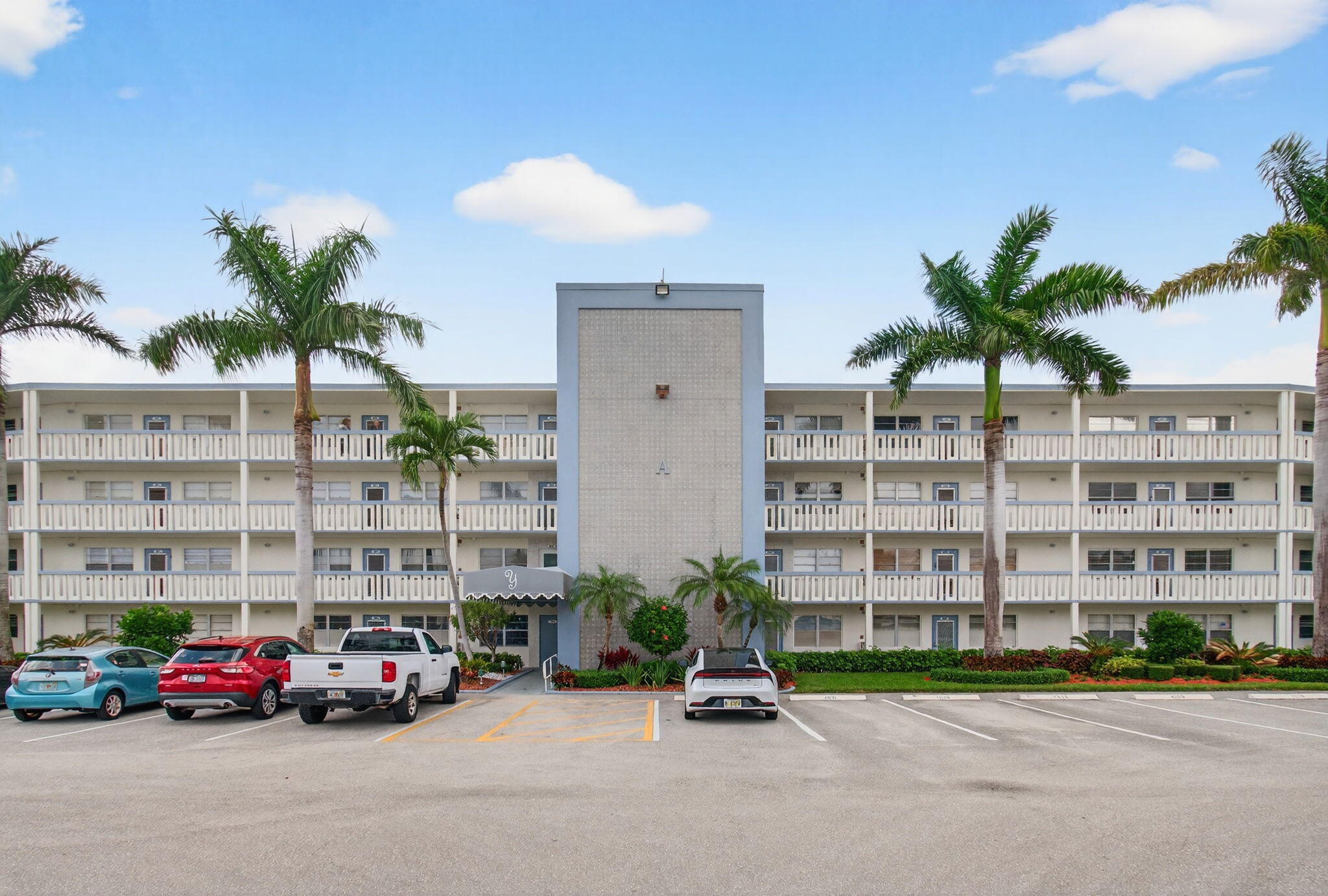 3007 Yarmouth C Boca Raton, FL 33434 - Photo 2 of 75 a car parked in front of a building with palm trees