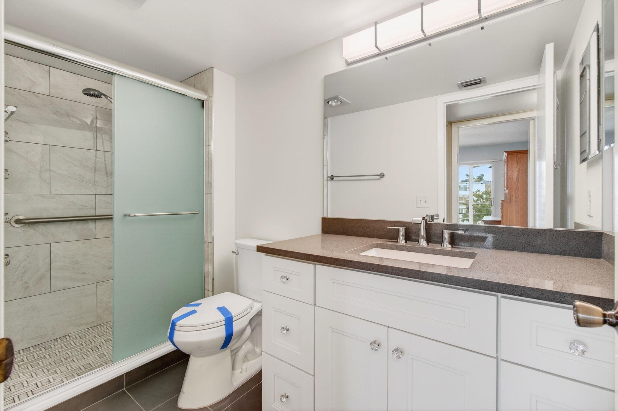 3007 Yarmouth C Boca Raton, FL 33434 - Photo 34 of 75 a bathroom with a granite countertop sink mirror vanity and toilet