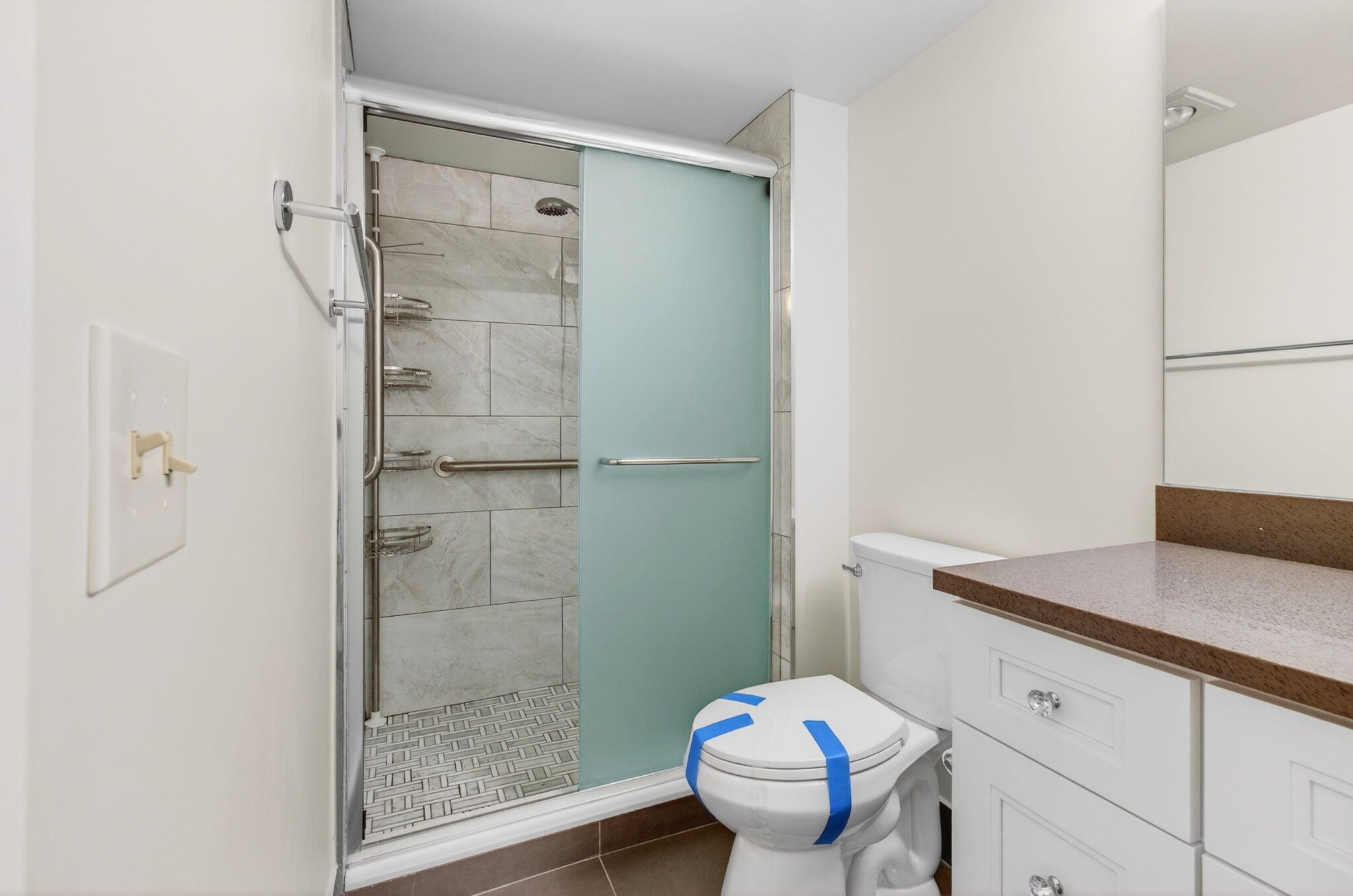 3007 Yarmouth C Boca Raton, FL 33434 - Photo 35 of 75 a bathroom with a granite countertop sink toilet and shower