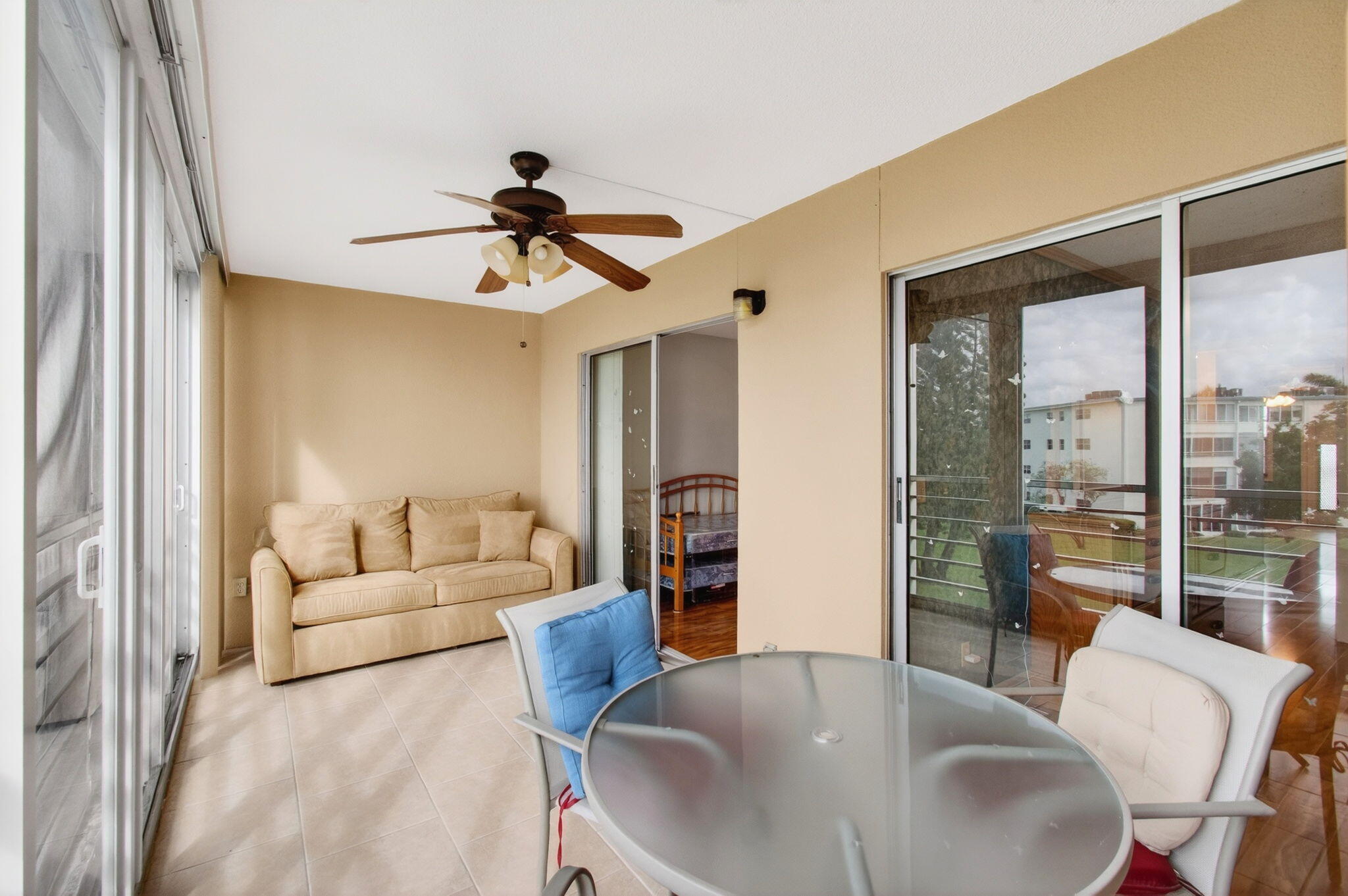 3007 Yarmouth C Boca Raton, FL 33434 - Photo 41 of 75 a living room with furniture a chandelier fan and a large window