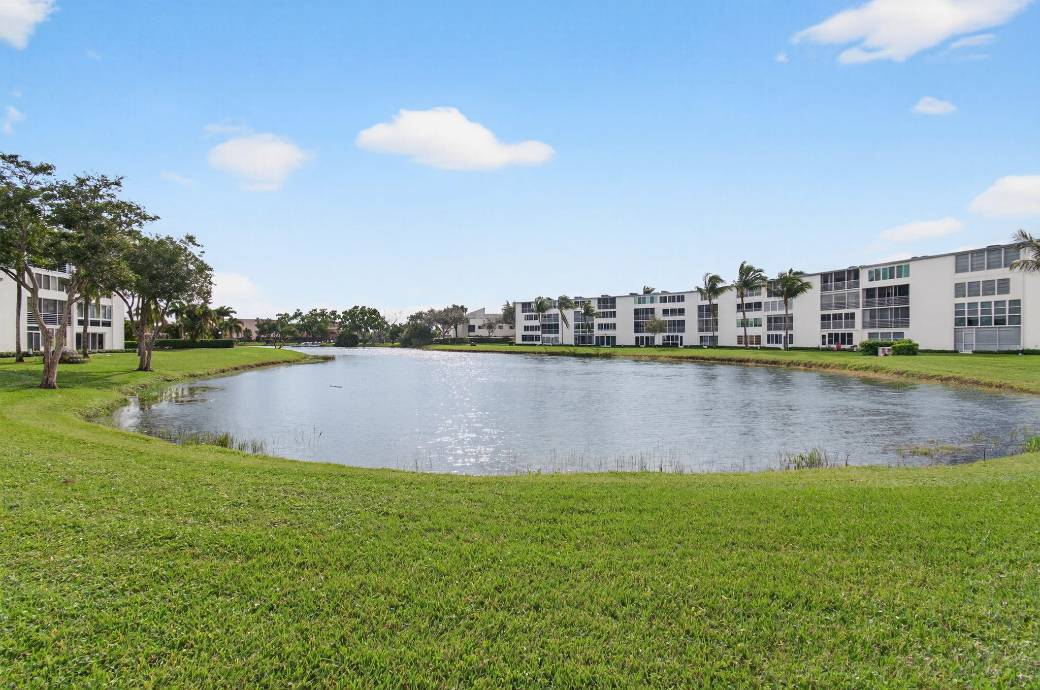 3007 Yarmouth C Boca Raton, FL 33434 - Photo 44 of 75 a view of a lake with houses in the back
