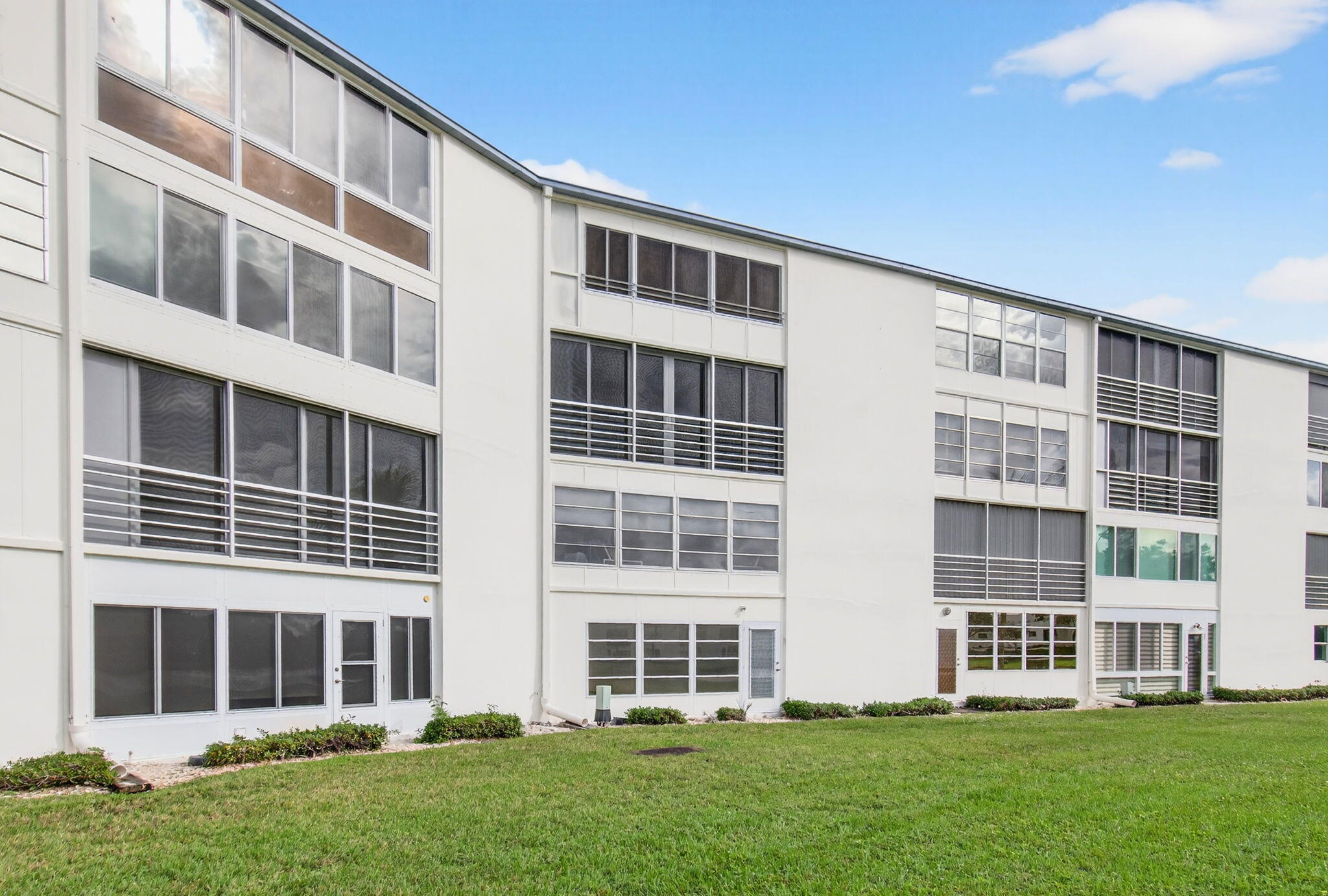3007 Yarmouth C Boca Raton, FL 33434 - Photo 46 of 75 a front view of a building with a yard