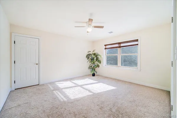 an empty room with windows and closet