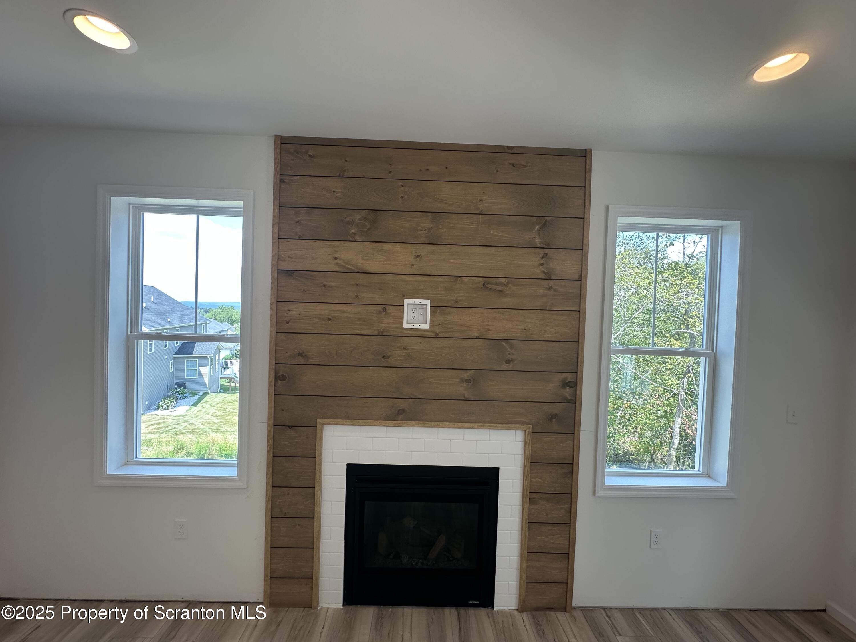 708 Pin Oak Place Moscow, PA 18444 - Photo 25 of 39 a living room with a fireplace and windows