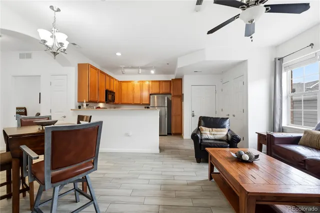 a living room with kitchen island furniture and a chandelier