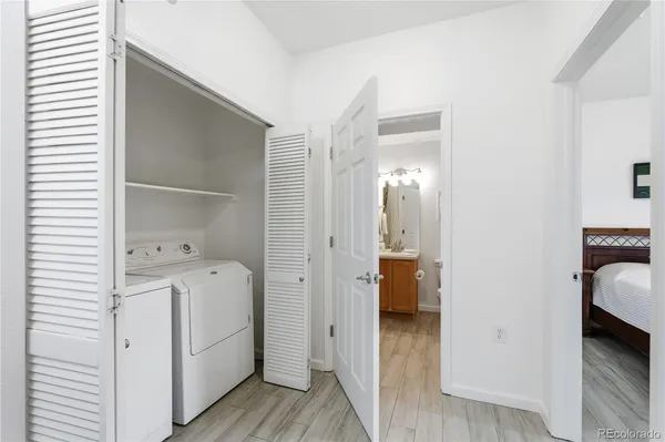 a view of walk in closet and bedroom