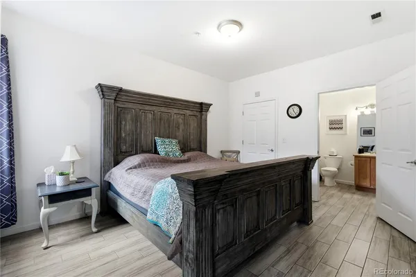 a spacious bedroom with a bed and a table