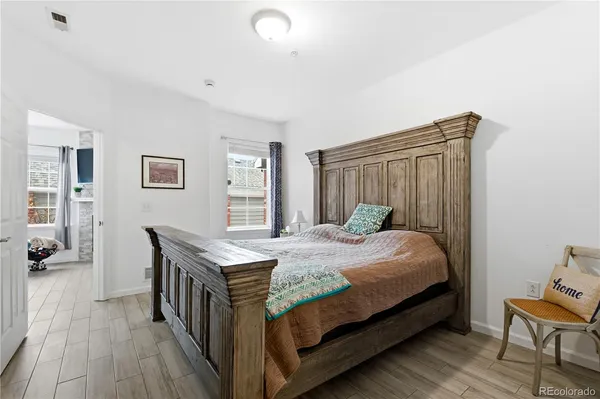 a bed room with a bed and a chair