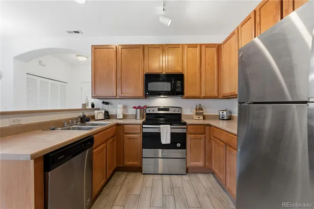 a kitchen with a sink stove and refrigerator