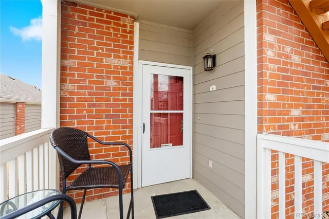 a view of a door with a chair and a window