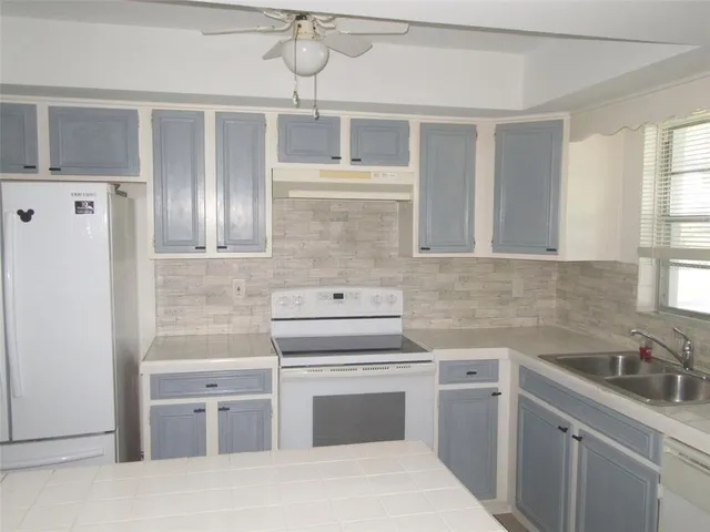 a kitchen with a stove oven and sink