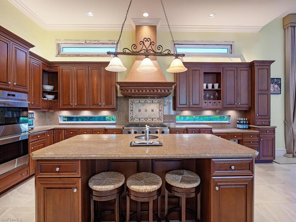 6955 Verde Way Naples, FL 34108 - Photo 12 of 42 a kitchen with a counter space cabinets and appliances