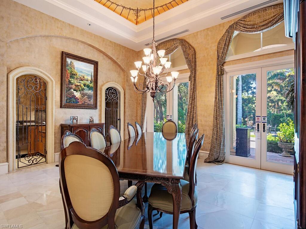 6955 Verde Way Naples, FL 34108 - Photo 16 of 42 a view of a dining room with furniture window and wooden floor