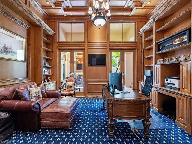a living room with furniture a chandelier and fireplace