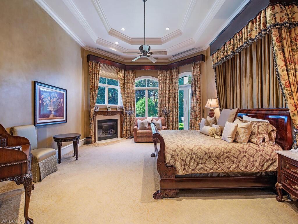 6955 Verde Way Naples, FL 34108 - Photo 21 of 42 a bedroom with a bed wooden floor and furniture
