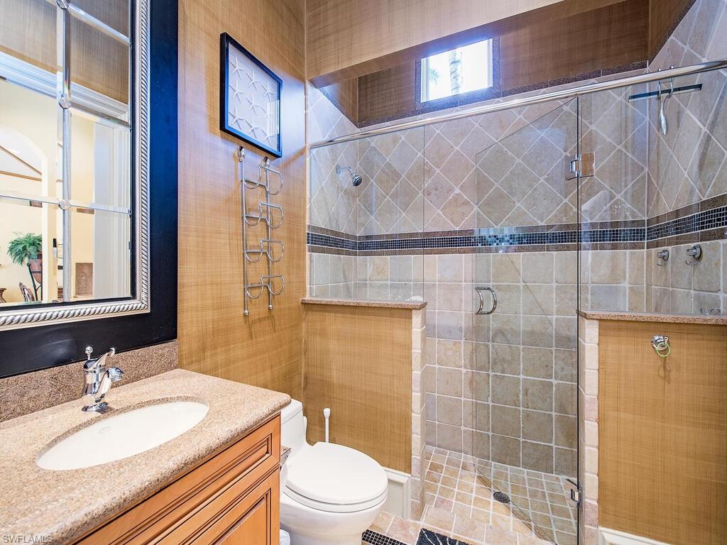 6955 Verde Way Naples, FL 34108 - Photo 25 of 42 a bathroom with a sink a toilet and shower
