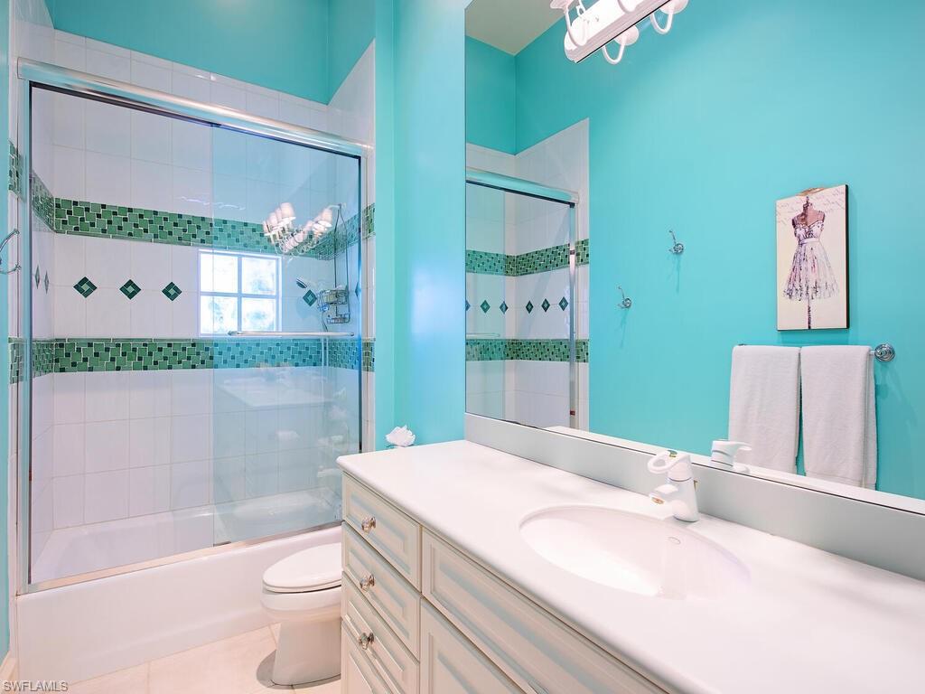 6955 Verde Way Naples, FL 34108 - Photo 27 of 42 a bathroom with a granite countertop sink mirror vanity and toilet