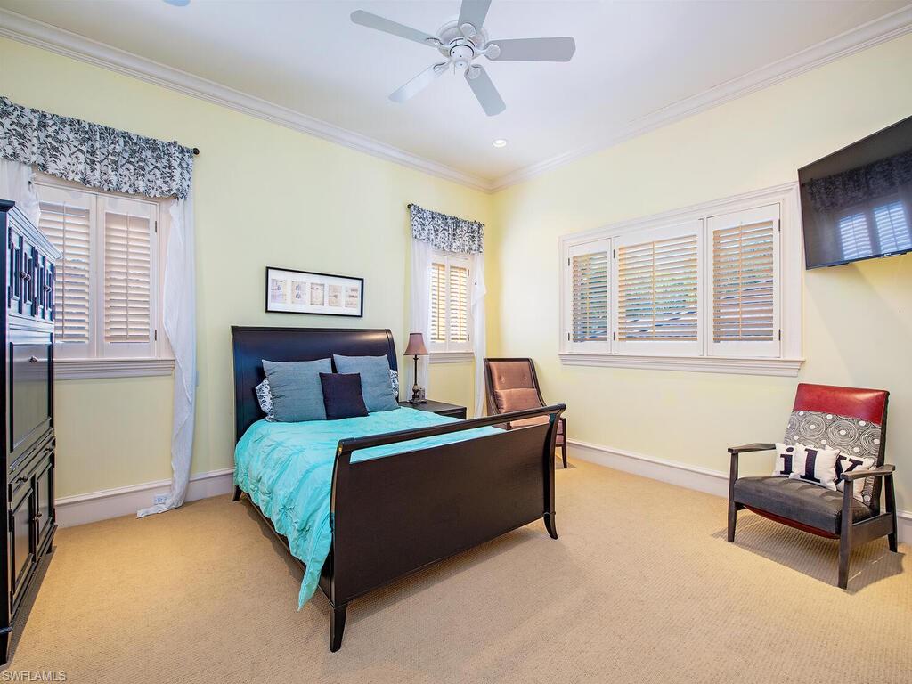6955 Verde Way Naples, FL 34108 - Photo 28 of 42 a bedroom with a bed and a couch