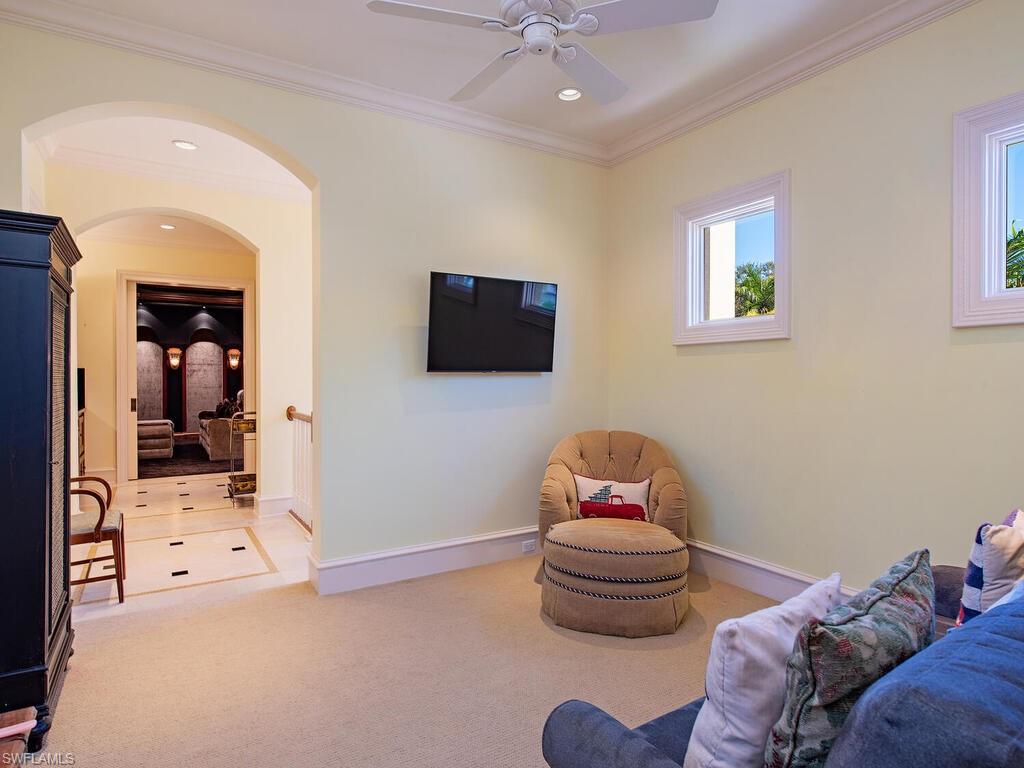 6955 Verde Way Naples, FL 34108 - Photo 32 of 42 a bedroom with a bed and a tv