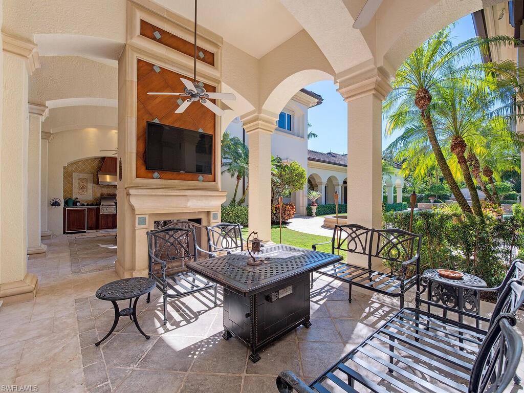 6955 Verde Way Naples, FL 34108 - Photo 35 of 42 a living room with patio furniture and a flat screen tv