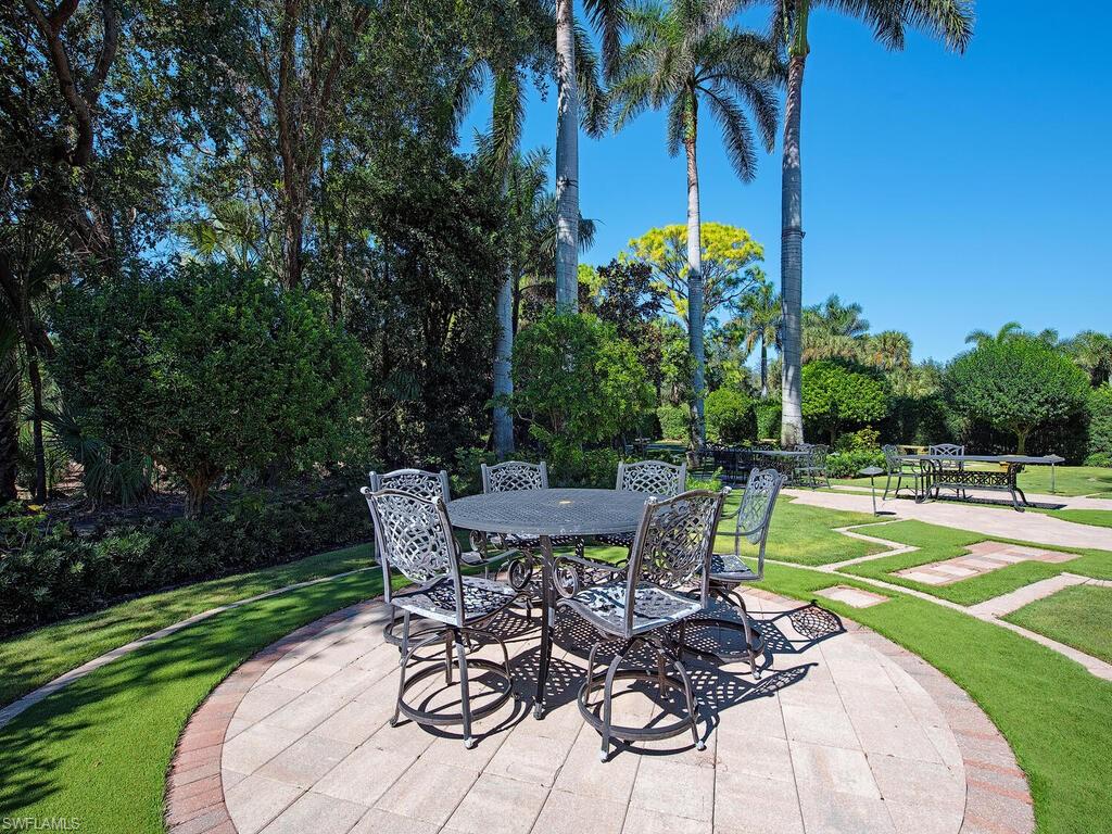 6955 Verde Way Naples, FL 34108 - Photo 39 of 42 a view of a backyard with sitting area