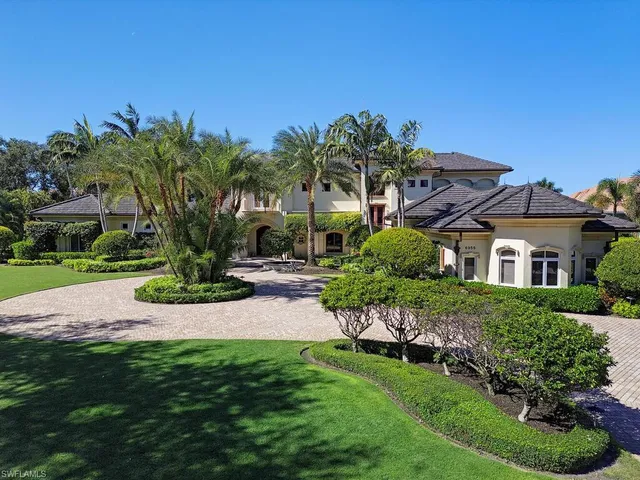 a house with green field in front of it