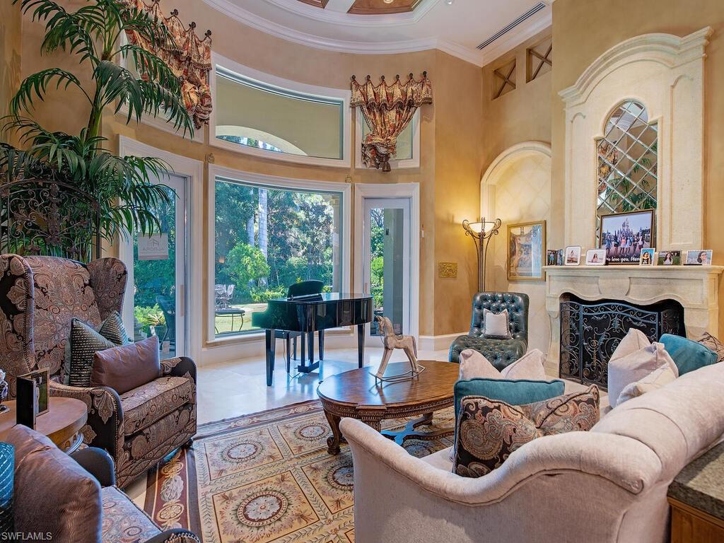 6955 Verde Way Naples, FL 34108 - Photo 10 of 42 a living room with furniture a fireplace and a potted plant